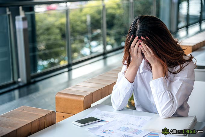 Best CBD oil for anxiety: a woman suffering from a lot of stress.