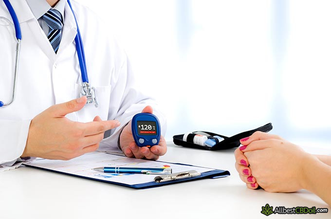 Best CBD oil for diabetes: a doctor holding a diabetes test machine.