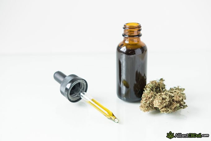 Does CBD get you high: bottle of CBD oil and marijuana