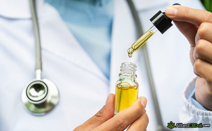 CBD tolerance: doctor holding CBD oil. CBD tolerance: doctor holding CBD oil.