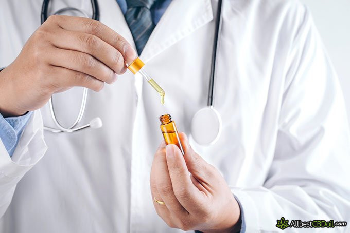 Does CBD get you high: doctor hold a bottle of CBD oil