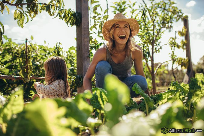 Endocannabinoid System and CBD: laughing, happy woman in a garden