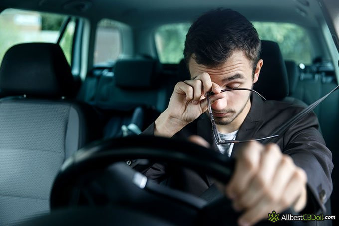 CBD oil side effects: man feeling drowsy while driving