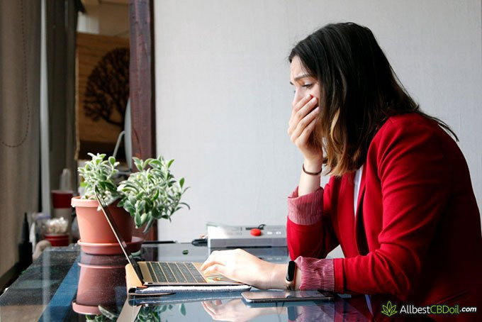 CBD oil diarrhea: woman tired at work